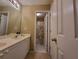 Bright bathroom with double vanity and a view into the shower, next to a white closet door at 4584 Madison Place Ln, Atlanta, GA 30360