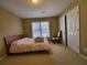 Carpeted bedroom with a window and closet; neutral walls and simple decor for a versatile space at 4584 Madison Place Ln, Atlanta, GA 30360