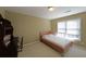 Simple bedroom with a twin bed, desk, and natural light streaming through the window at 4584 Madison Place Ln, Atlanta, GA 30360