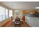 Cozy breakfast nook with a glass table, four chairs, and plenty of natural light at 4584 Madison Place Ln, Atlanta, GA 30360