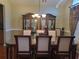 Elegant dining room with a classic chandelier, ornate china cabinet, and seating for six at 4584 Madison Place Ln, Atlanta, GA 30360