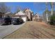 Inviting two-story brick home featuring an attached two-car garage and lush landscaping at 4584 Madison Place Ln, Atlanta, GA 30360