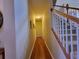 Hallway featuring hardwood floors and a staircase with white banisters at 4584 Madison Place Ln, Atlanta, GA 30360