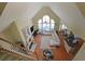 Open-concept living room with vaulted ceilings, large windows, and a fireplace flowing into the kitchen at 4584 Madison Place Ln, Atlanta, GA 30360