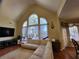 Open concept living room with hardwood floors, large windows, vaulted ceiling, and comfortable seating at 4584 Madison Place Ln, Atlanta, GA 30360