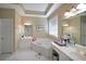 Bright main bathroom with dual sinks, a large bathtub, and plenty of counter space at 4584 Madison Place Ln, Atlanta, GA 30360