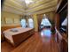 Another view of the large main bedroom featuring hardwood floors, sitting area, and a tray ceiling at 4584 Madison Place Ln, Atlanta, GA 30360