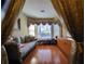 A sitting area with hardwood floors, bay windows, custom valances, and comfortable seating at 4584 Madison Place Ln, Atlanta, GA 30360