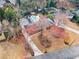 Aerial view of a residence featuring a pool, driveway, and landscaping at 4755 Huntley Dr, Atlanta, GA 30342