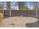 A backyard featuring a stone firepit, mulch, gravel, and a wooden fence at 4755 Huntley Dr, Atlanta, GA 30342