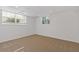 Cozy basement room with carpet flooring, and natural light from above ground windows at 4755 Huntley Dr, Atlanta, GA 30342