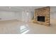 Spacious basement features a brick fireplace, neutral carpet, and white columns for an inviting entertainment space at 4755 Huntley Dr, Atlanta, GA 30342