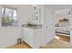 Granite vanity and white cabinets with a view to the backyard and a doorway to a bedroom at 4755 Huntley Dr, Atlanta, GA 30342