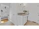 Well-lit bathroom with granite vanity, white cabinets, and a doorway leading to a bedroom at 4755 Huntley Dr, Atlanta, GA 30342