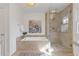 Modern bathroom features soaking tub, glass shower, and tiled floors at 4755 Huntley Dr, Atlanta, GA 30342