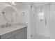 Modern bathroom with white subway tile shower, penny tile floor and gray vanity with marble top at 4755 Huntley Dr, Atlanta, GA 30342