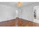 Bedroom featuring hardwood floors, white wainscoting, and a woven light fixture at 4755 Huntley Dr, Atlanta, GA 30342