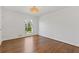 Bright bedroom with hardwood floors, white wainscoting, and a large window at 4755 Huntley Dr, Atlanta, GA 30342