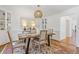 Bright dining room featuring a modern table, stylish chairs, and elegant built-in display cabinets at 4755 Huntley Dr, Atlanta, GA 30342