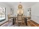 Bright dining room featuring a modern table, stylish chairs, and elegant built-in display cabinets at 4755 Huntley Dr, Atlanta, GA 30342