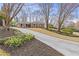 Long driveway leading up to a beautiful brick home with lush landscaping and mature trees at 4755 Huntley Dr, Atlanta, GA 30342