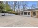 Exterior of a house featuring a large driveway area, and a basketball hoop at 4755 Huntley Dr, Atlanta, GA 30342