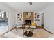 Comfortable living room featuring a brick fireplace, built in shelving, and outdoor views at 4755 Huntley Dr, Atlanta, GA 30342