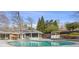 Backyard oasis featuring a swimming pool, porch, landscaping, and mature trees at 4755 Huntley Dr, Atlanta, GA 30342