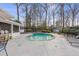 Inviting backyard pool area with mature landscaping, chaise lounges, and screened in porch at 4755 Huntley Dr, Atlanta, GA 30342