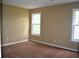 Empty bedroom with neutral walls, carpeted floor, and natural light from two windows, ready for personalization at 100 Shoreline Dr, Fayetteville, GA 30215