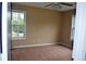 Carpeted bedroom with two windows offering natural light and views, complemented by a ceiling fan at 100 Shoreline Dr, Fayetteville, GA 30215