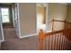 Upstairs hallway with carpet, natural light and view into other rooms of the house at 100 Shoreline Dr, Fayetteville, GA 30215