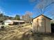 View of the house and shed in the backyard surrounded by a lawn at 1010 Wesley Park Sw Dr, Marietta, GA 30064