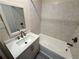 Bathroom featuring tiled walls, shower over tub, and a vanity with a sink at 1010 Wesley Park Sw Dr, Marietta, GA 30064