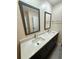 Bathroom features a double sink vanity with modern faucets and framed mirrors at 1010 Wesley Park Sw Dr, Marietta, GA 30064