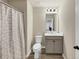 Neutrally painted bathroom with a combined toilet, sink and cabinet, and a tiled shower at 1734 Cadence St, Locust Grove, GA 30248