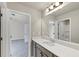 Bathroom featuring neutral walls, a long mirror, a sink and two doorways at 1734 Cadence St, Locust Grove, GA 30248