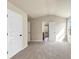 Bedroom featuring neutral walls, carpeted floors, and two doorways at 1734 Cadence St, Locust Grove, GA 30248