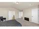 Large bedroom featuring neutral walls, carpeted floors, a queen bed, and two doorways at 1734 Cadence St, Locust Grove, GA 30248