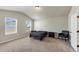 Spacious bedroom featuring neutral walls, carpeted floors, a queen bed, and two windows at 1734 Cadence St, Locust Grove, GA 30248