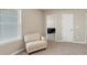 Bedroom with neutral walls, a comfortable chair by the window and a doorway to another room at 1734 Cadence St, Locust Grove, GA 30248