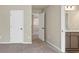 Bedroom featuring neutral walls, carpeted floors, and a doorway to a bathroom at 1734 Cadence St, Locust Grove, GA 30248