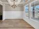 Dining room with trey ceiling, chandelier, hardwood floors, wainscotting and large windows at 1734 Cadence St, Locust Grove, GA 30248