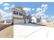 A view of the home's exterior showing its three car garage, brick facade, and concrete driveway at 1734 Cadence St, Locust Grove, GA 30248