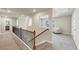 Upstairs hallway features an overlook and leads to a cozy seating area with great natural light at 1734 Cadence St, Locust Grove, GA 30248