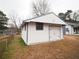 Exterior of a one-car detached garage with white siding and a blue trim at 2084 North Rd, Snellville, GA 30078