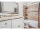 Well-lit bathroom with granite counters, decorative mirror, and shower-tub combo at 4704 Keighley Dr, Stone Mountain, GA 30083