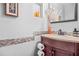 Elegant powder room features a granite countertop and decorative wall accents at 4704 Keighley Dr, Stone Mountain, GA 30083