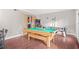 Fun game room with a pool table, air hockey, and hardwood floors at 4704 Keighley Dr, Stone Mountain, GA 30083