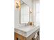 Bright bathroom boasts marble countertop vanity, soaking tub, and large window with natural light at 513 Saint Charles Ne Ave, Atlanta, GA 30308